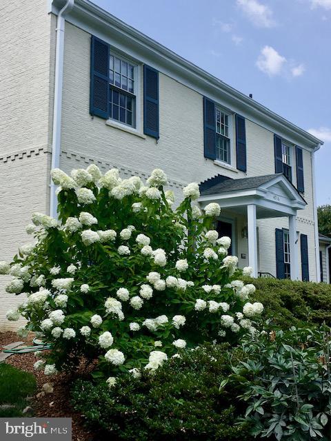 4716 Merivale Road Chevy Chase, MD 20815 - Photo 43 of 48 a front view of a house with lots of flowers