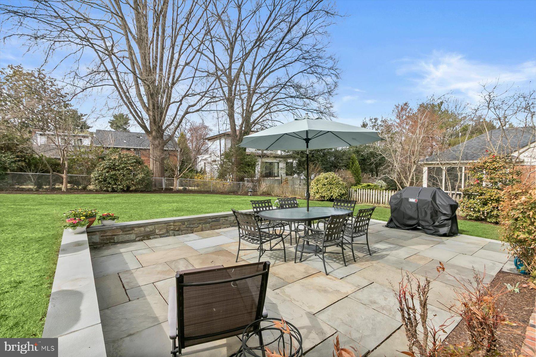 4716 Merivale Road Chevy Chase, MD 20815 - Photo 5 of 48 a patio with a table and chairs under an umbrella
