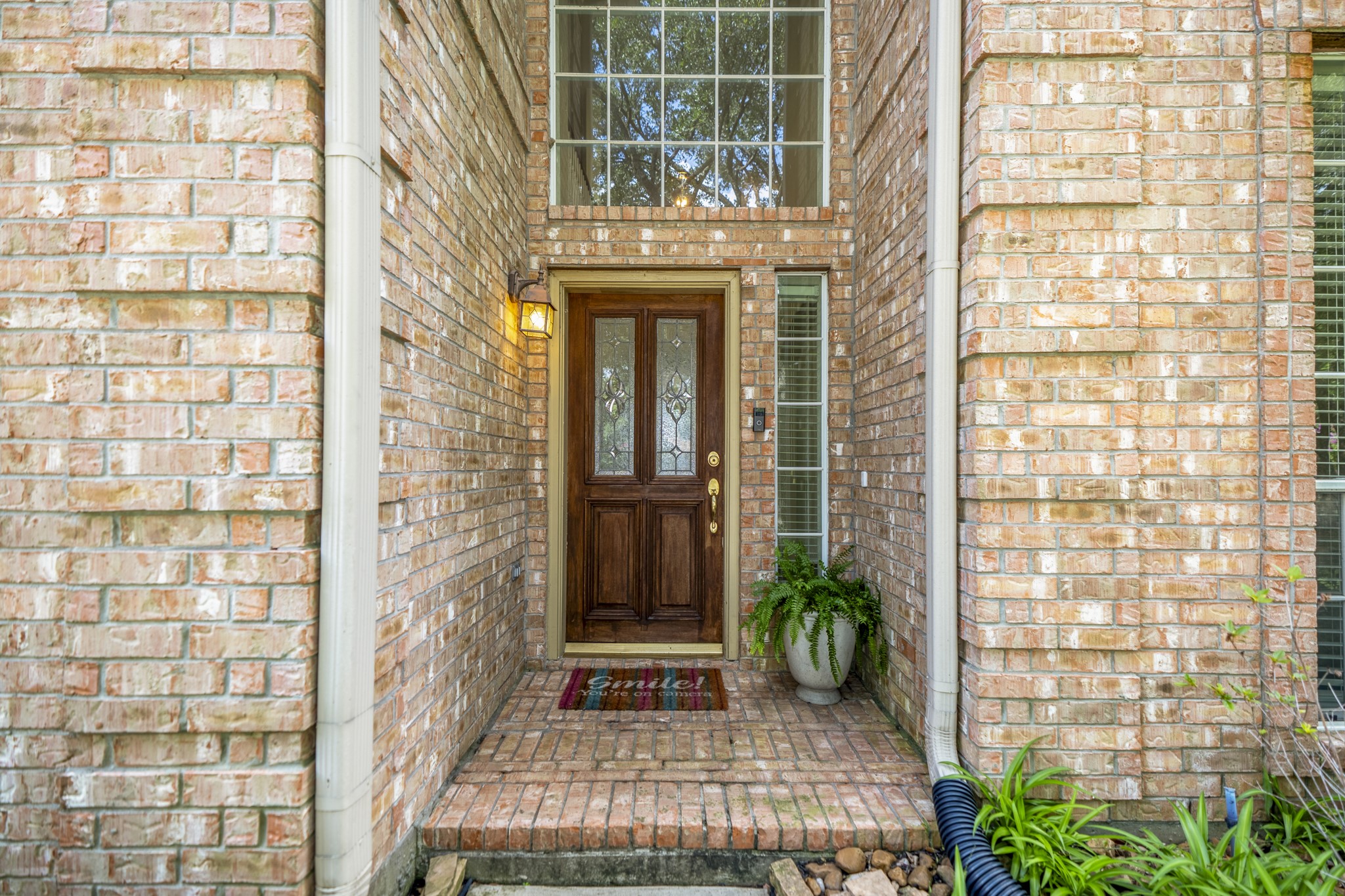 5807 Sequoia Trace Court Spring, TX 77379 - Photo 3 of 50 A shaded brick entry creates a welcoming first impression, setting the tone for a Windrose home designed around space, comfort, and golf course living just beyond the backyard.