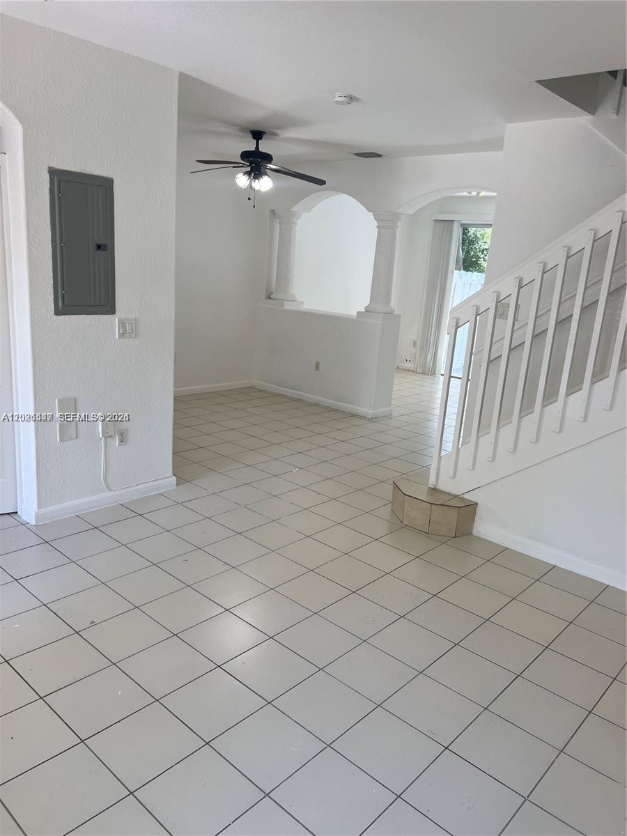 2910 Southeast 15th Road, Unit 55 Homestead, FL 33035 - Photo 5 of 13 an empty room with wooden floor and staircase