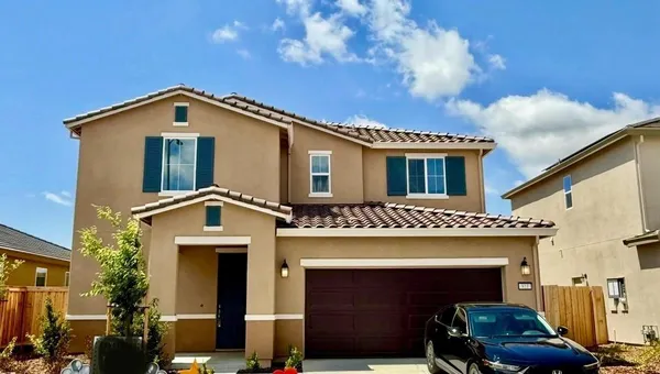 a front view of a house with yard