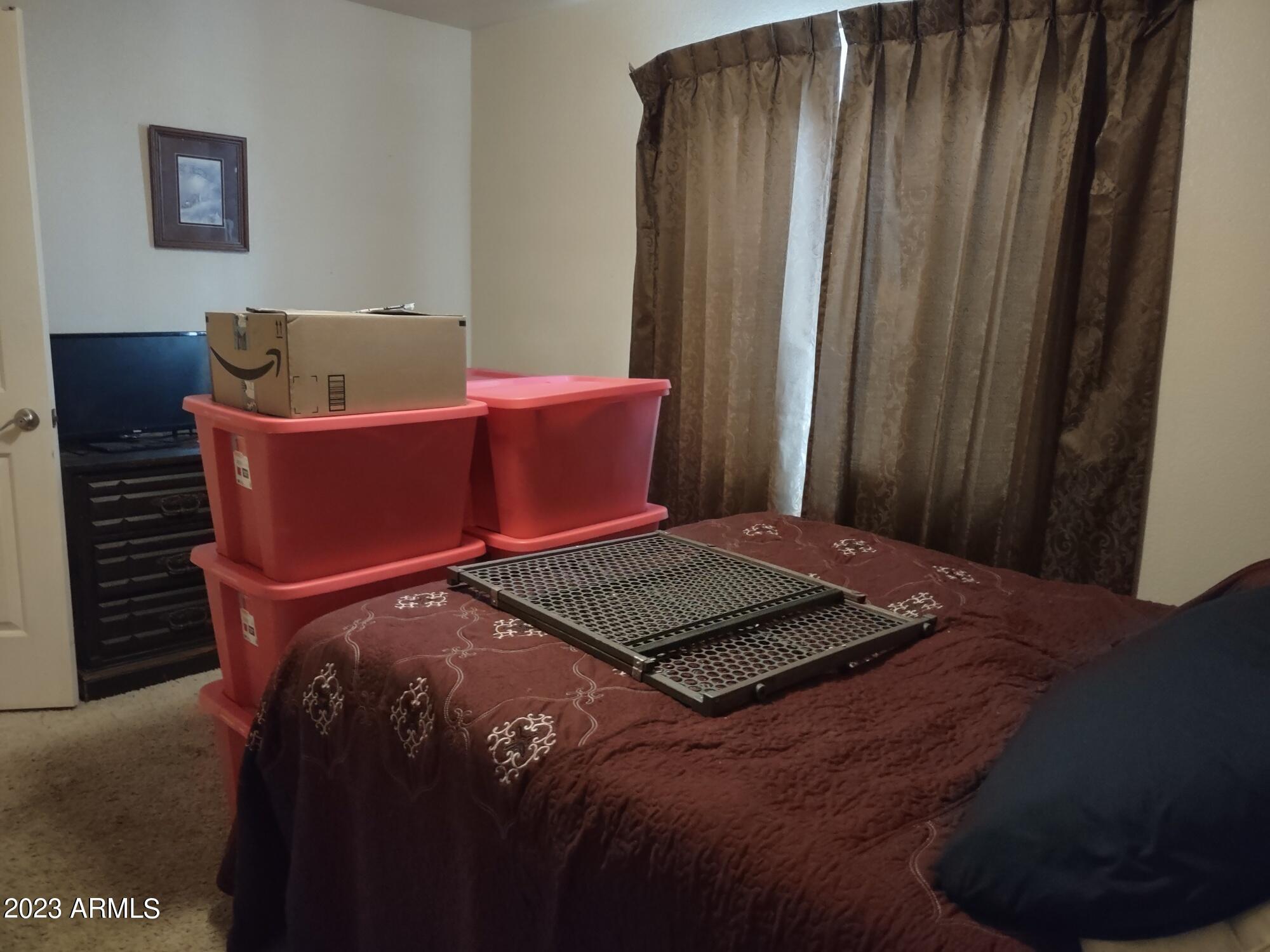 4145 Bluff Road Golden Valley, AZ 86413 - Photo 7 of 16 a bed sitting in a bedroom next to a window