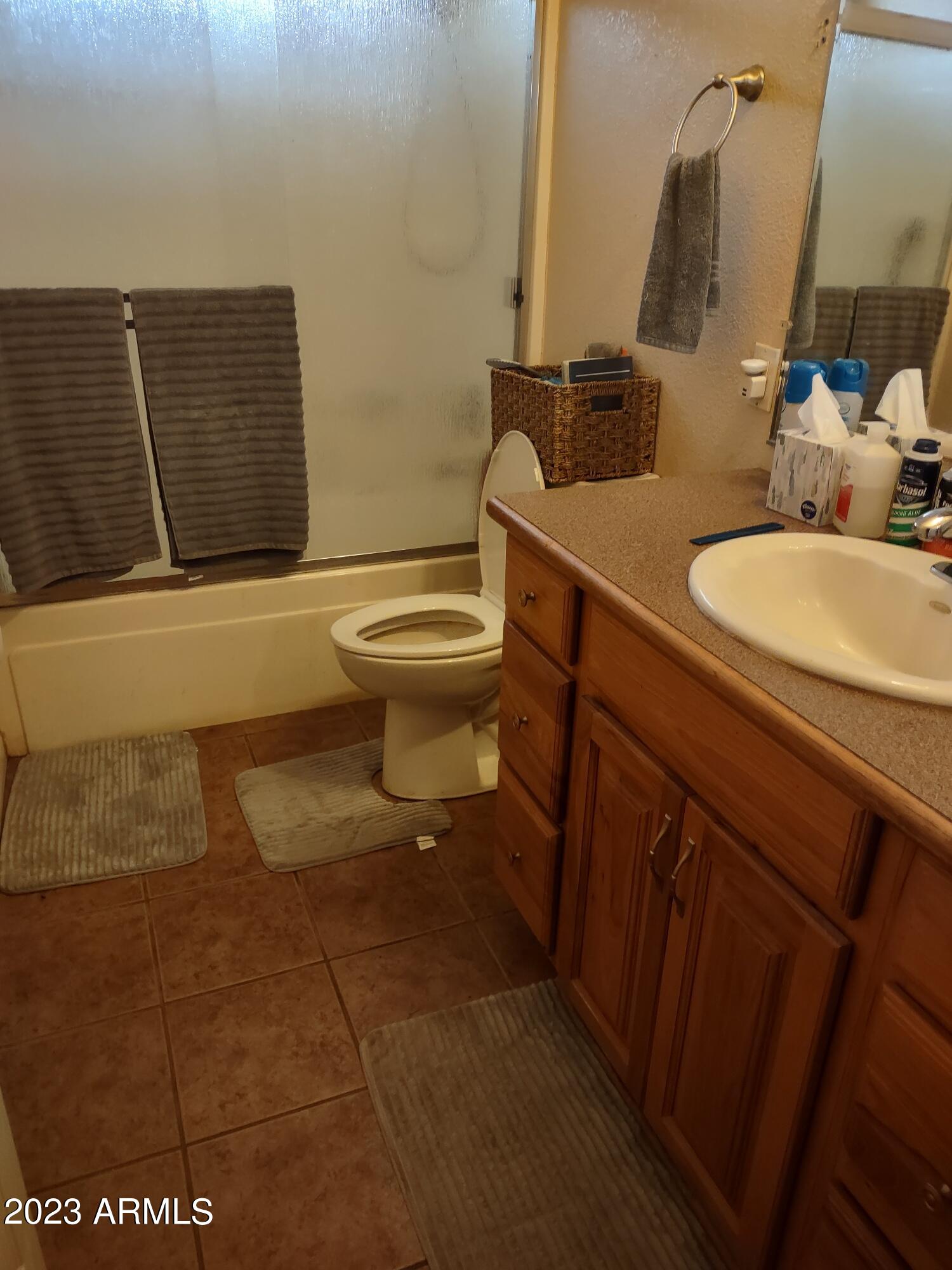 4145 Bluff Road Golden Valley, AZ 86413 - Photo 8 of 16 a bathroom with a granite countertop toilet sink and mirror