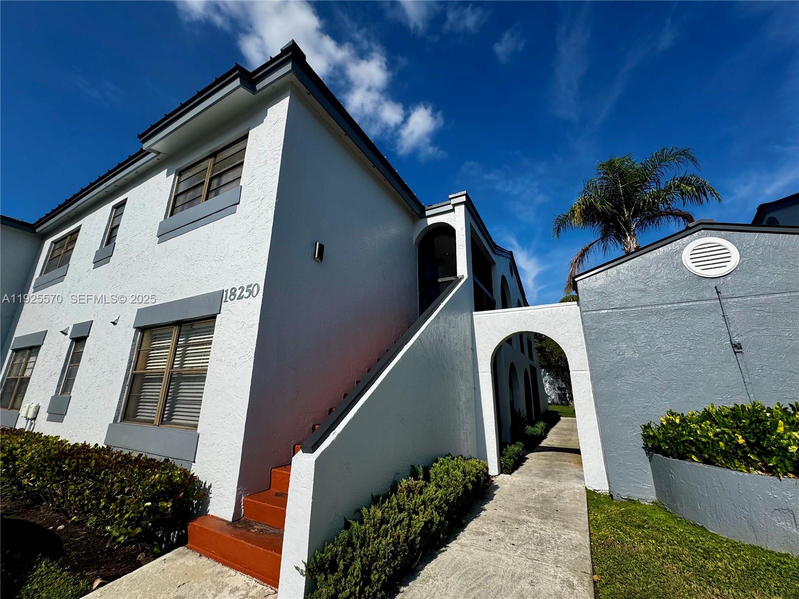 18250 Mediterranean Boulevard, Unit 1508 Hialeah, FL 33015 - Photo 26 of 26 a front view of a house with a yard