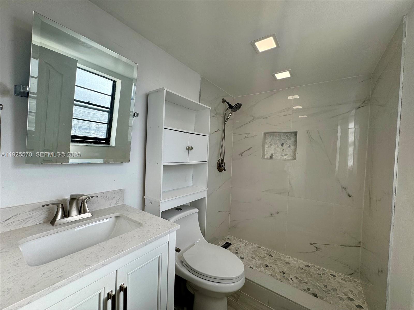 18250 Mediterranean Boulevard, Unit 1508 Hialeah, FL 33015 - Photo 5 of 26 a bathroom with a granite countertop sink a toilet and shower
