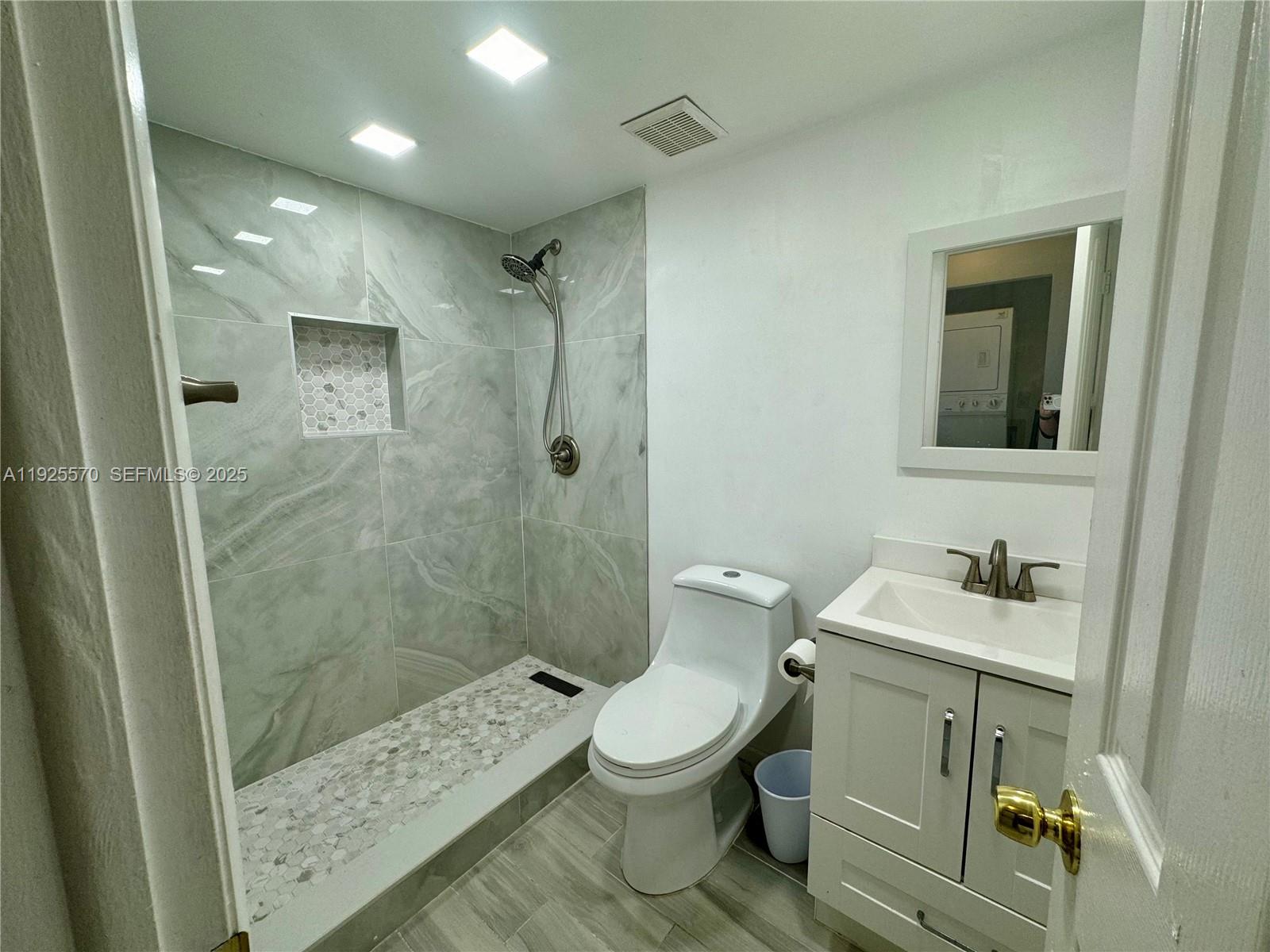 18250 Mediterranean Boulevard, Unit 1508 Hialeah, FL 33015 - Photo 8 of 26 a bathroom with a sink a toilet and shower