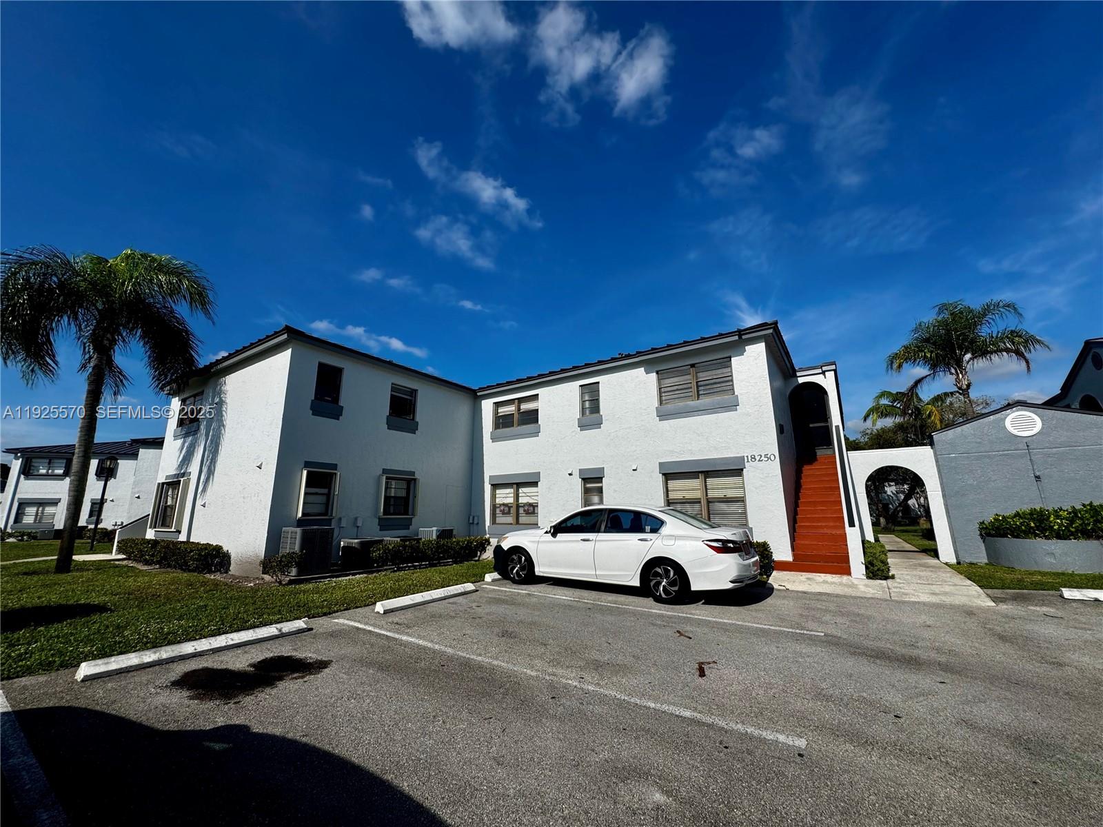 18250 Mediterranean Boulevard, Unit 1508 Hialeah, FL 33015 - Photo 10 of 26 a view of a car parked in front of a house