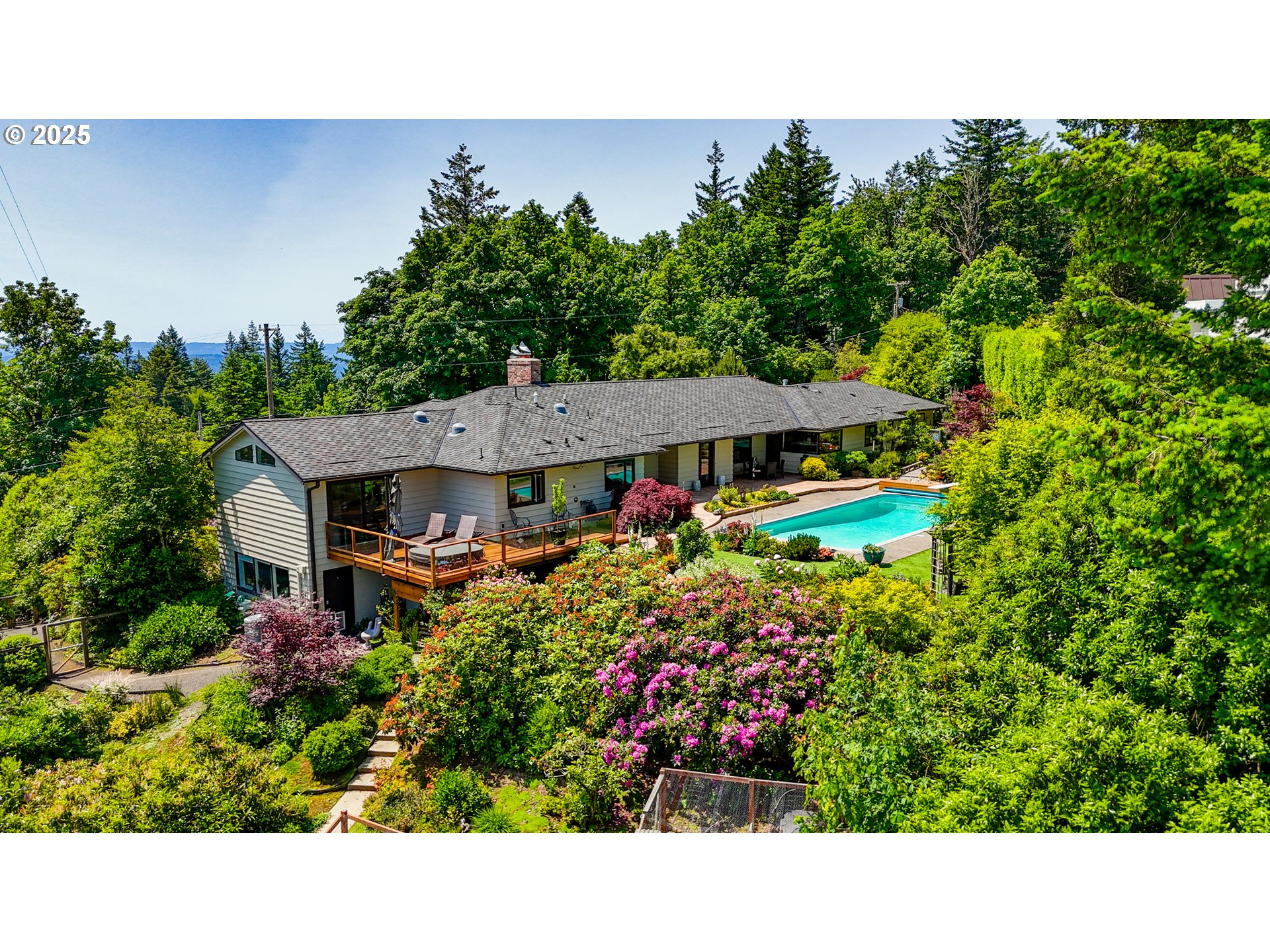 7131 Northwest Penridge Road Portland, OR 97229 - Photo 1 of 43 a view of a house with a small yard and a garden