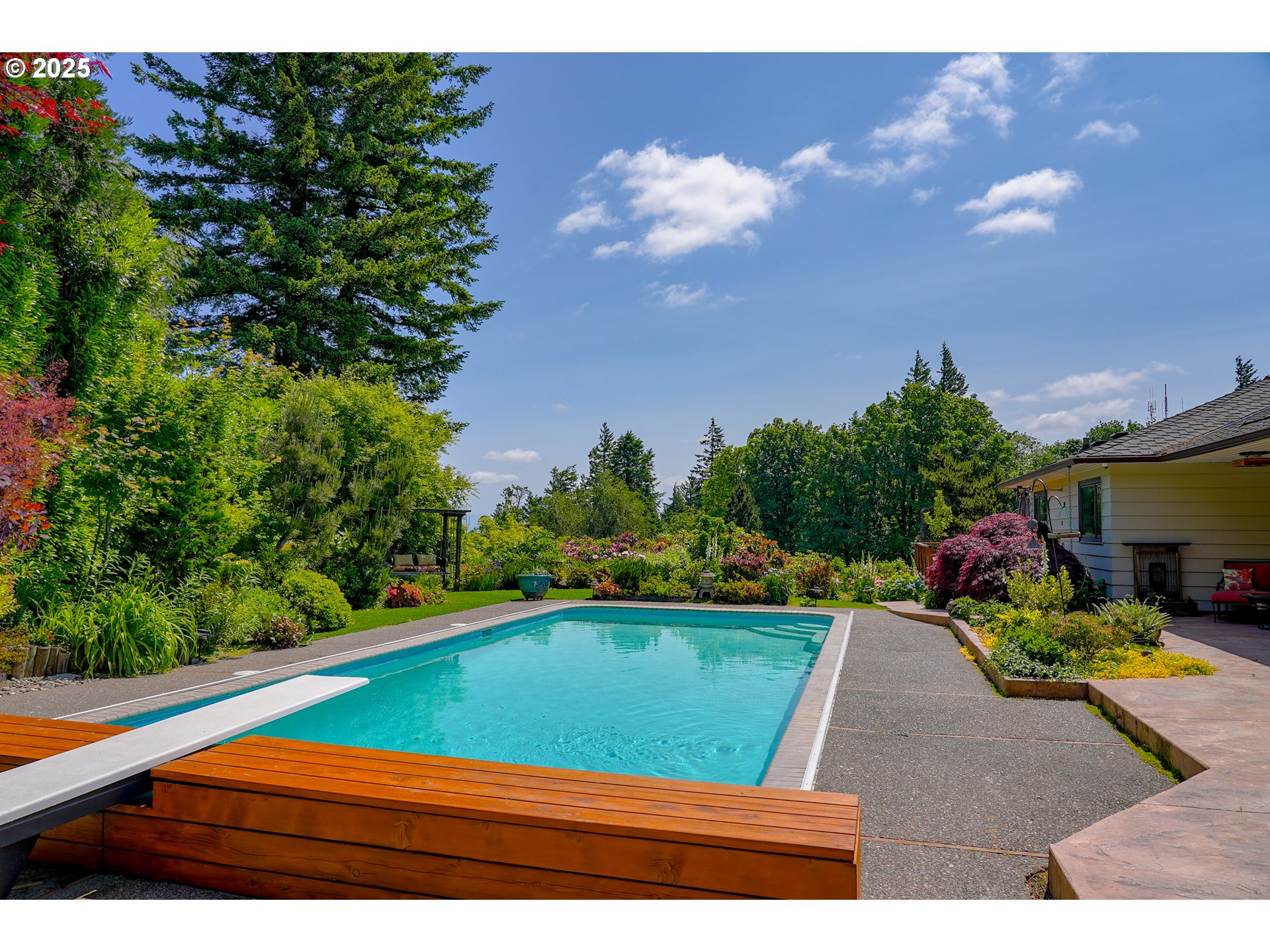 7131 Northwest Penridge Road Portland, OR 97229 - Photo 14 of 43 a view of swimming pool with seating area and trees in the background