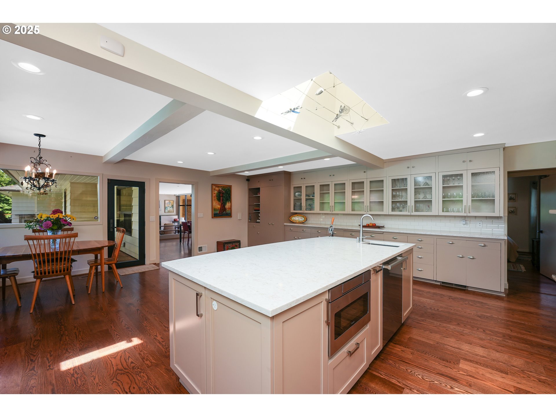 7131 Northwest Penridge Road Portland, OR 97229 - Photo 28 of 43 a kitchen that has a stove a table and chairs in it