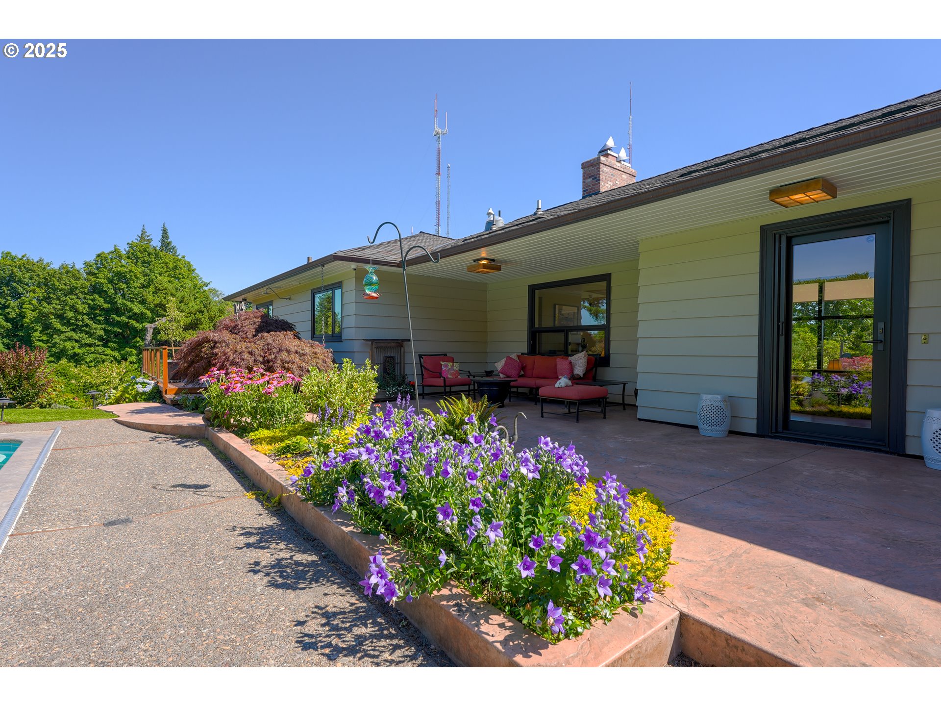 7131 Northwest Penridge Road Portland, OR 97229 - Photo 40 of 43 a front view of a house with a yard and a bench