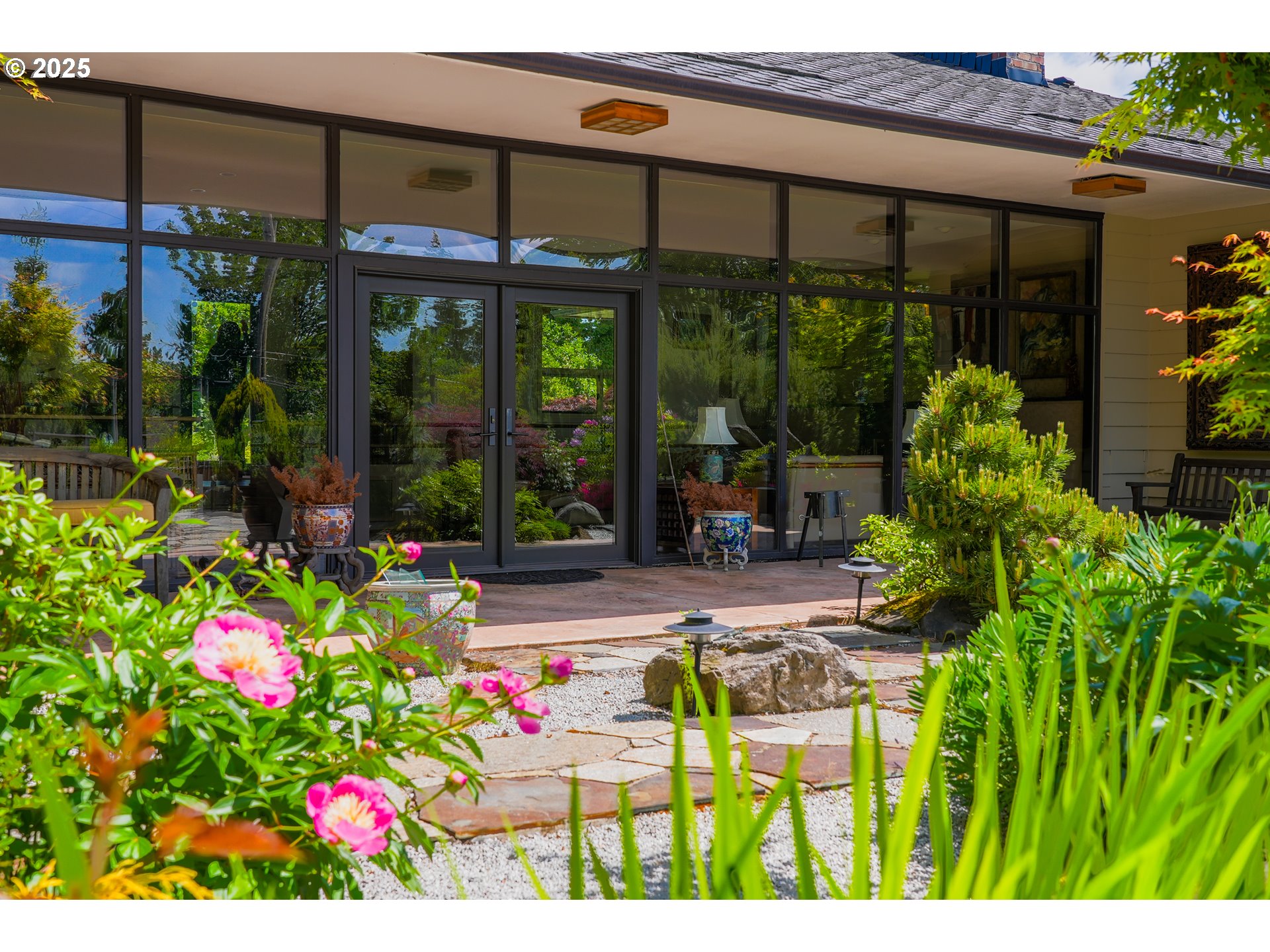 7131 Northwest Penridge Road Portland, OR 97229 - Photo 9 of 43 a view of yellow house with flower garden