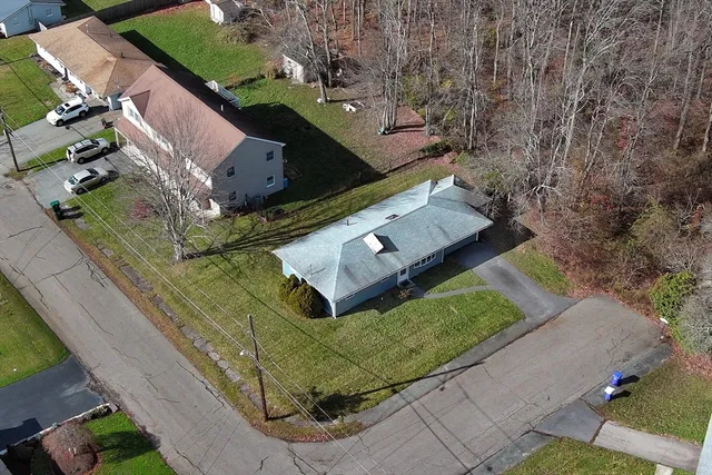 an aerial view of a house with outdoor space