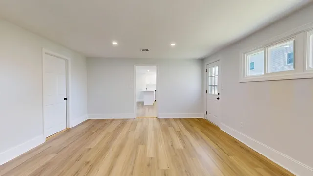 a view of a room with wooden floor and brick walls