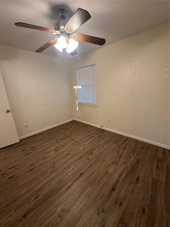 120 Don Propp Road Azle, TX 76020 - Photo 13 of 22 an empty room with wooden floor fan and window