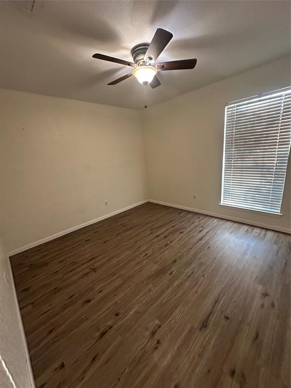 120 Don Propp Road Azle, TX 76020 - Photo 14 of 22 an empty room with wooden floor fan and windows