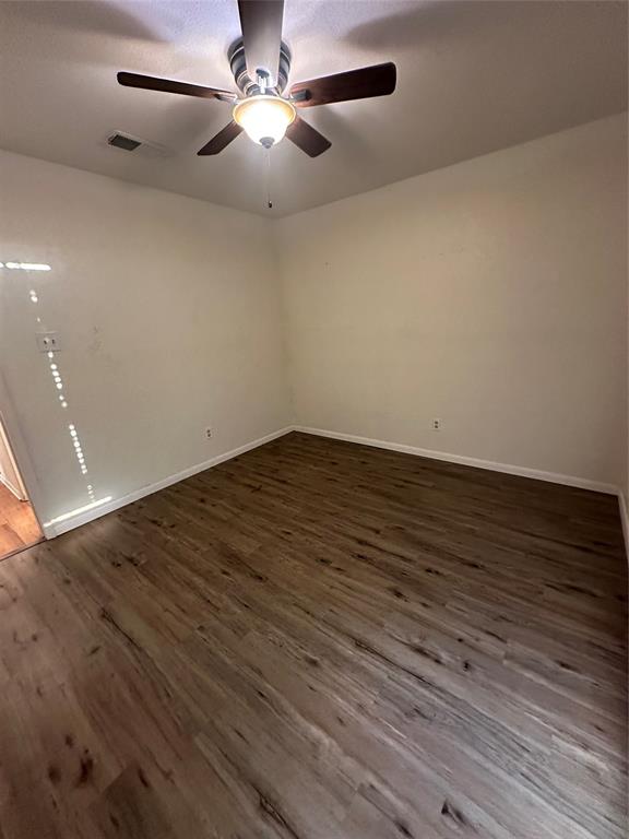 120 Don Propp Road Azle, TX 76020 - Photo 17 of 22 an empty room with wooden floor fan and window