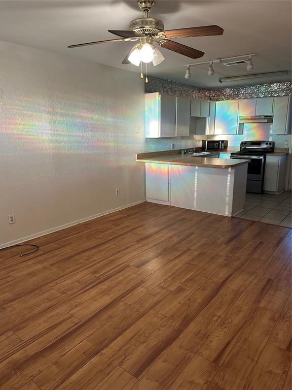 120 Don Propp Road Azle, TX 76020 - Photo 5 of 22 a kitchen with granite countertop stainless steel appliances and wooden cabinets