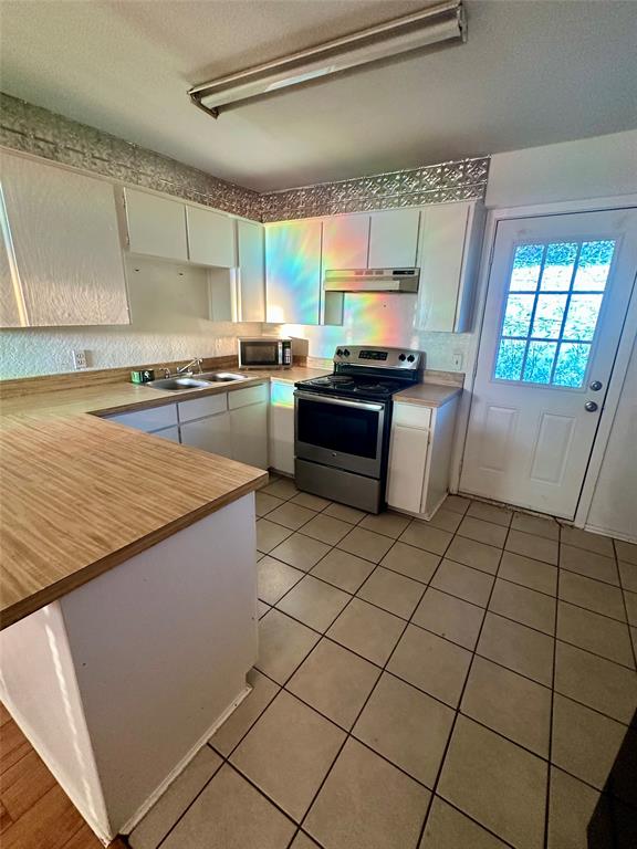 120 Don Propp Road Azle, TX 76020 - Photo 7 of 22 a kitchen with stainless steel appliances granite countertop a sink and a stove