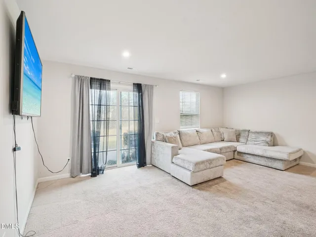 a living room with furniture and a floor to ceiling window