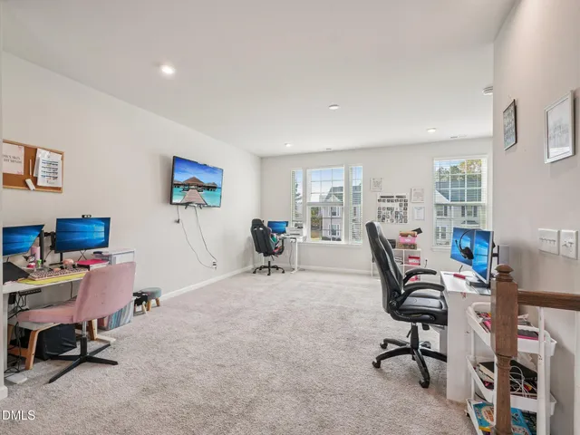 a view of a workspace with furniture and a workspace