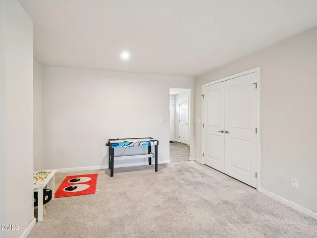a bedroom with a bed and white walls