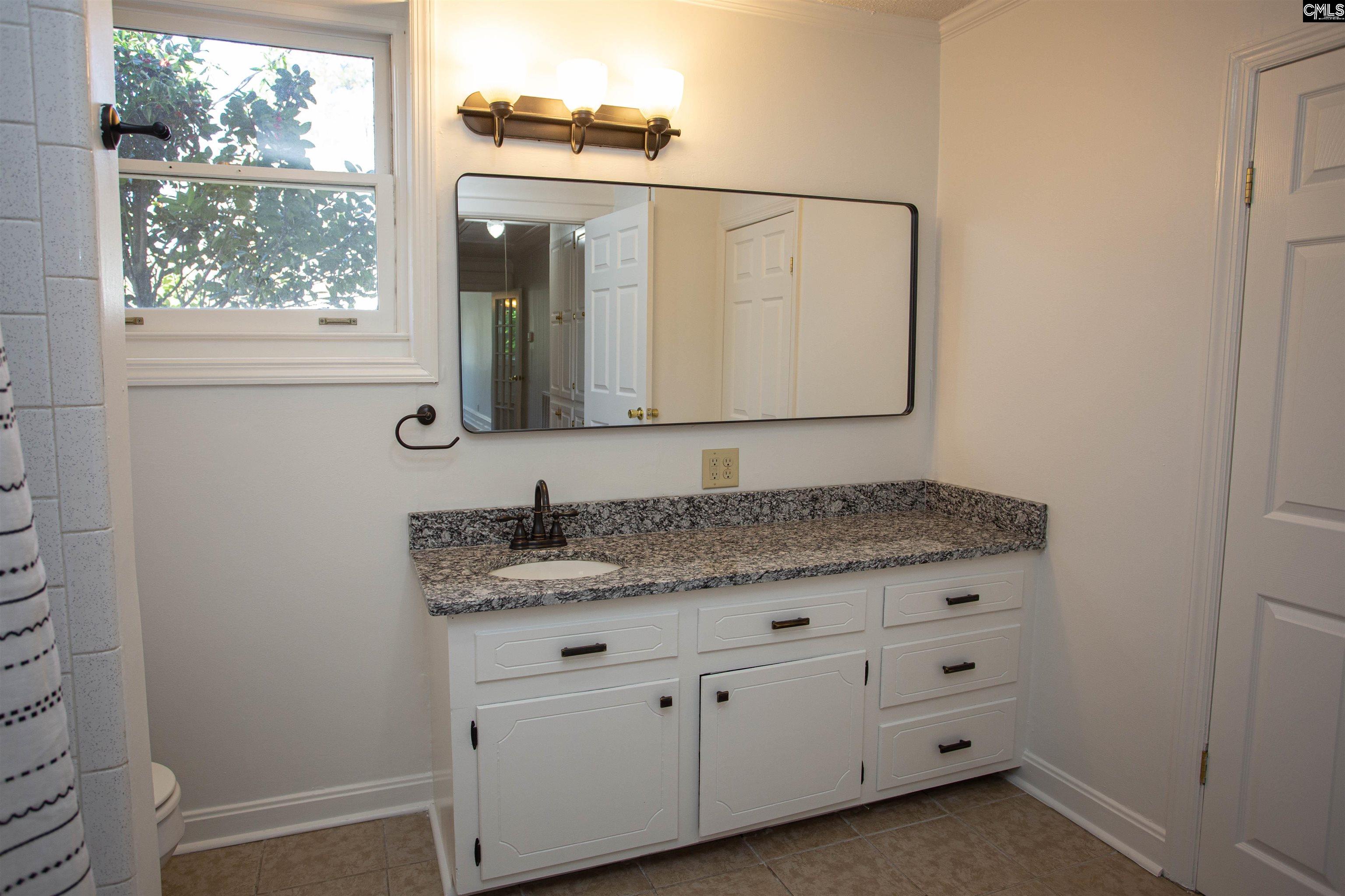 1700 Broad Street Camden, SC 29020 - Photo 19 of 41 a bathroom with a granite countertop sink and a mirror
