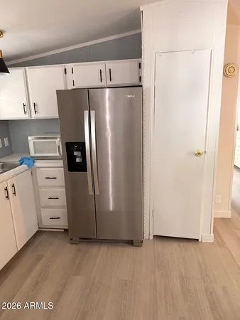 a kitchen with cabinets and stainless steel appliances