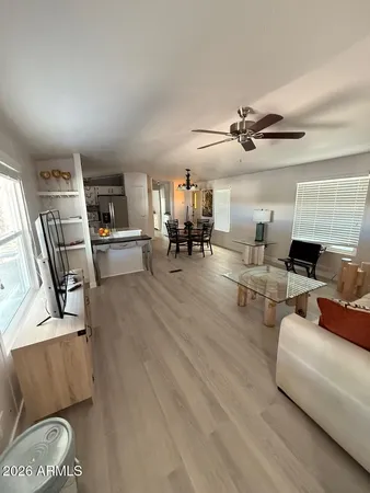 a living room with furniture and a chandelier