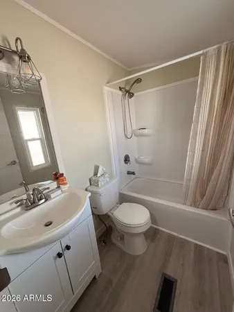 a bathroom with a sink a mirror a toilet and bathtub