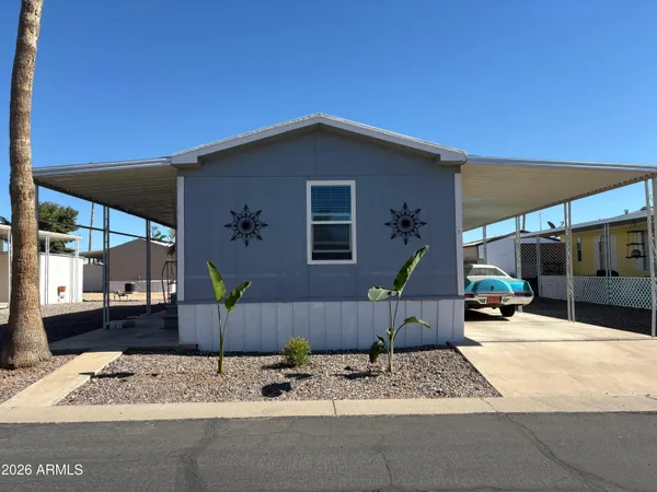 a backyard of a house with sofas fire pit and outdoor seating