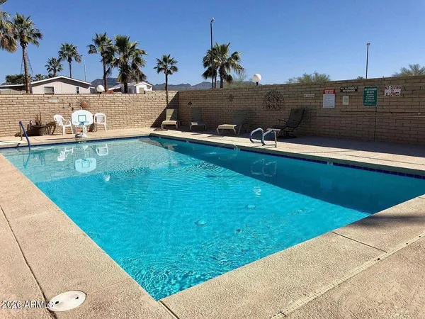 a view of a swimming pool with a yard