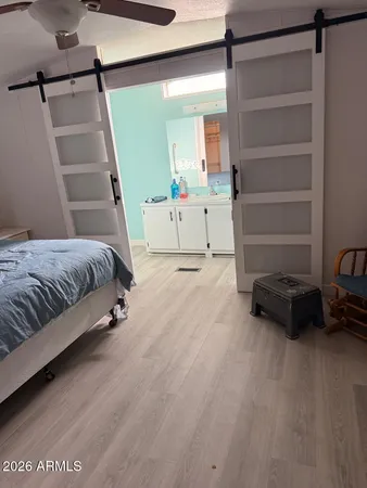 a spacious bedroom with a bed and a window