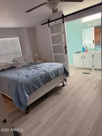 a spacious bedroom with a bed and a window