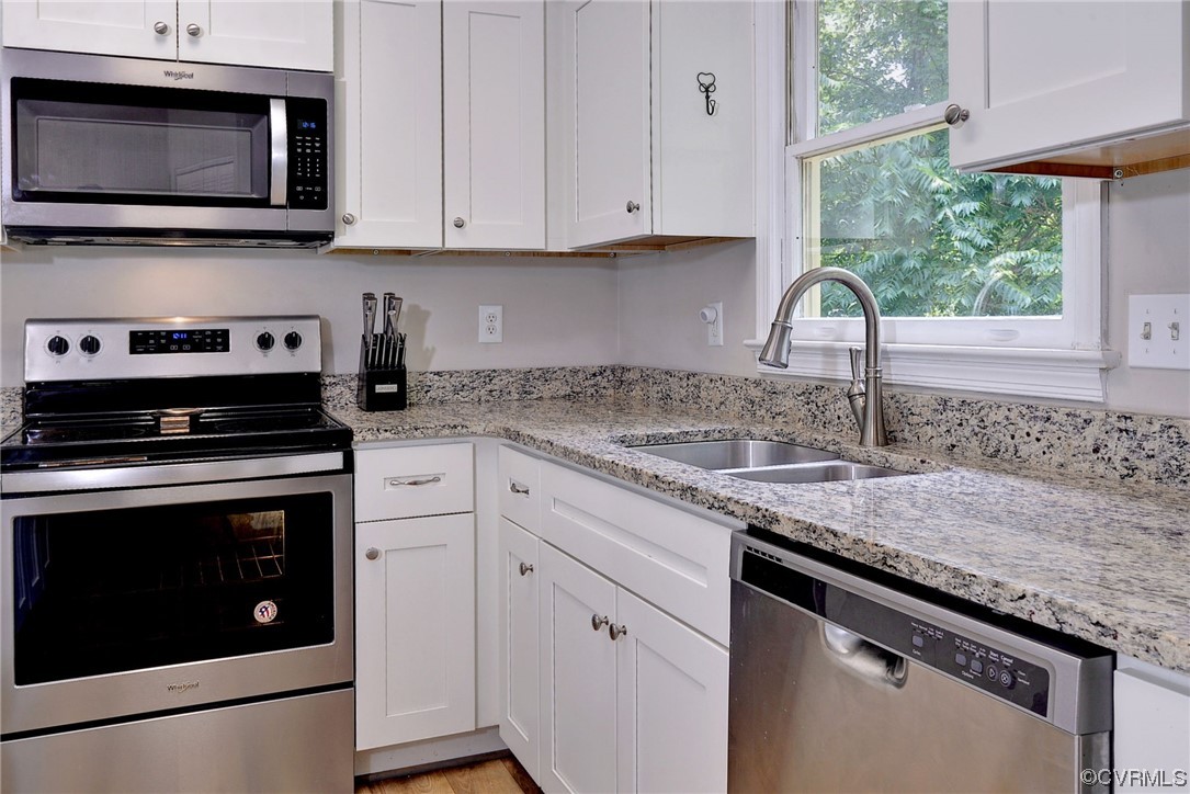 250 Reflection Drive Williamsburg, VA 23188 - Photo 16 of 42 a kitchen with granite countertop a sink cabinets and stainless steel appliances
