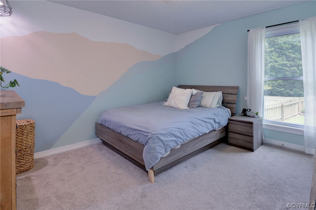 250 Reflection Drive Williamsburg, VA 23188 - Photo 22 of 42 a spacious bedroom with a bed and a window