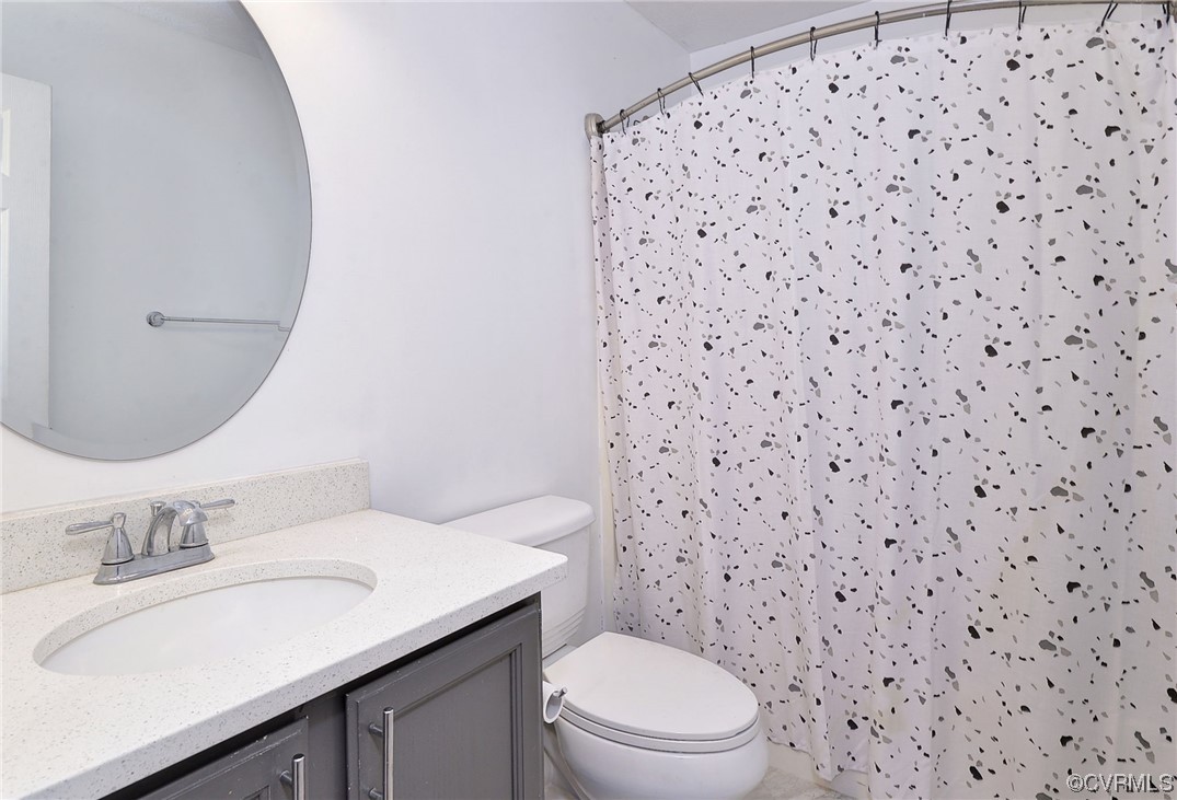 250 Reflection Drive Williamsburg, VA 23188 - Photo 24 of 42 a bathroom with a granite countertop sink a toilet and a mirror
