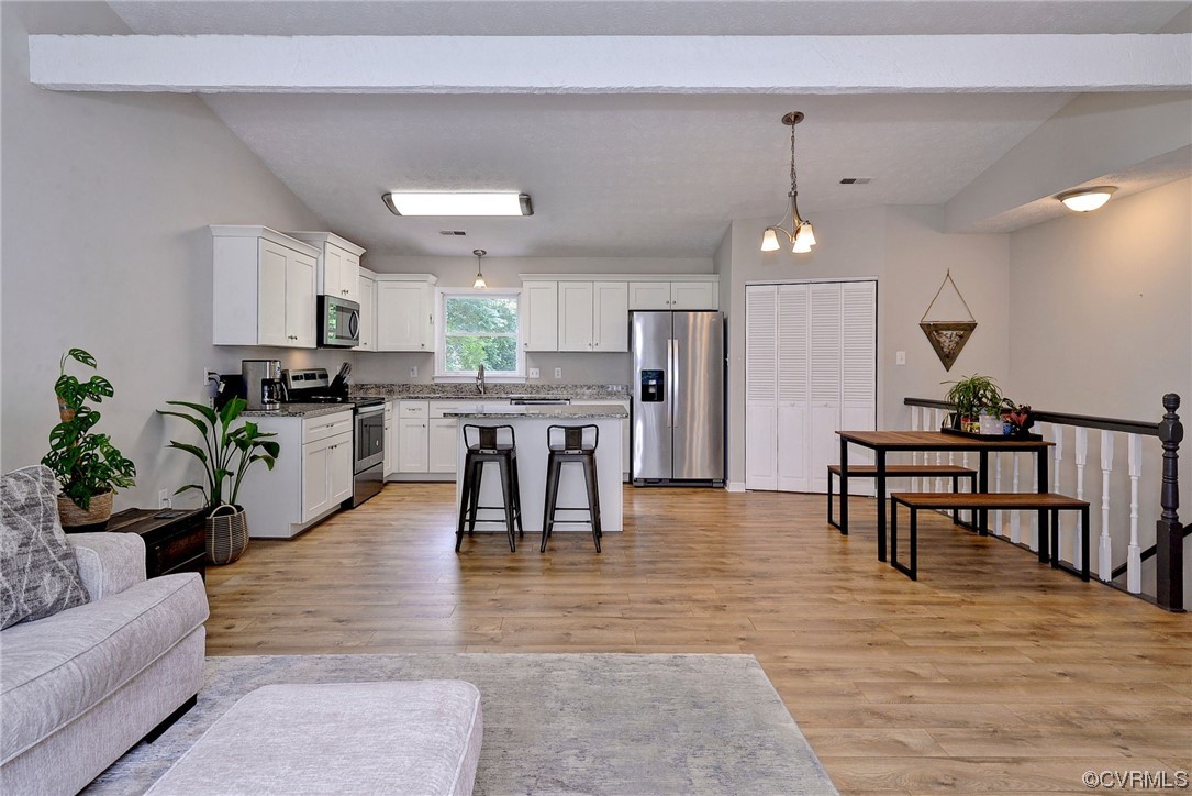 250 Reflection Drive Williamsburg, VA 23188 - Photo 10 of 42 a living room with furniture and kitchen view
