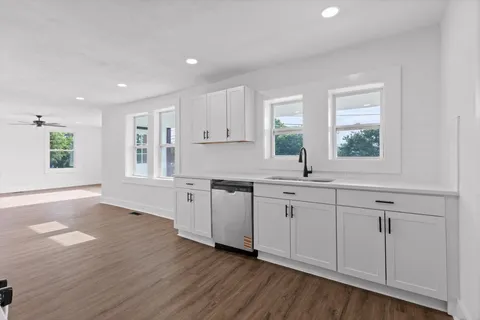 a kitchen with sink cabinets and wooden floor