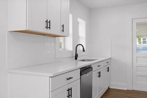 a kitchen with stainless steel appliances a sink and a stove