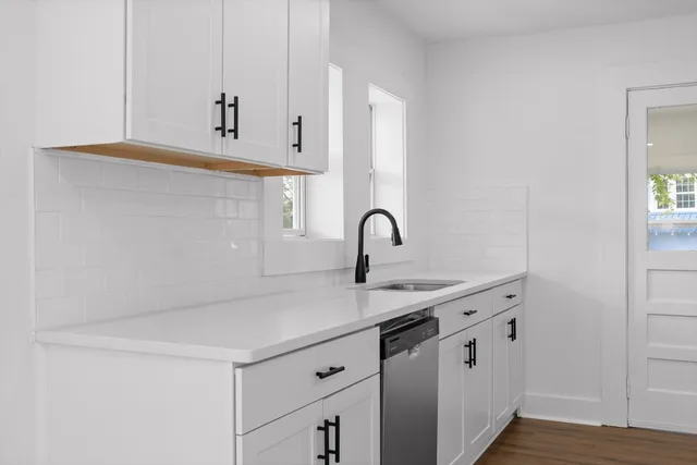 a kitchen with stainless steel appliances a sink and a stove