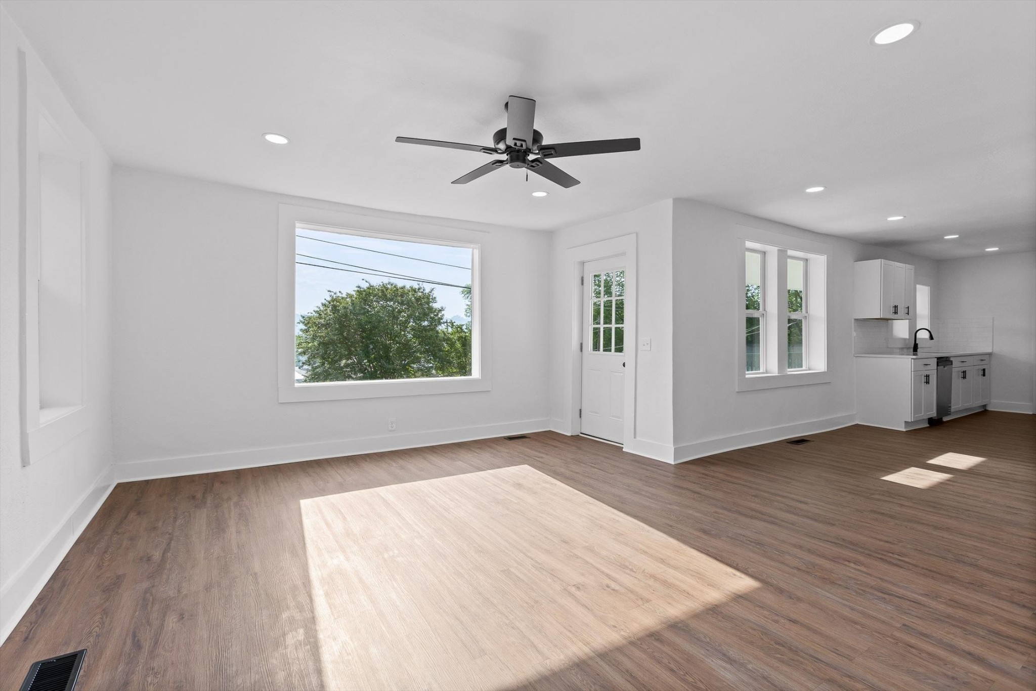 2917 East Crescent Circle Chattanooga, TN 37407 - Photo 19 of 45 an empty room with wooden floor a ceiling fan and windows