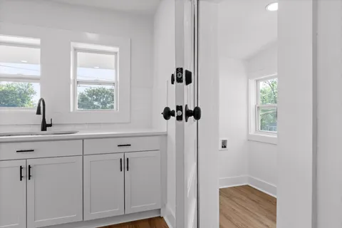 a bathroom with a sink a window and shower