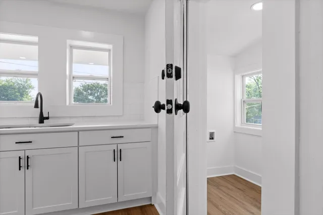 a bathroom with a sink a window and shower