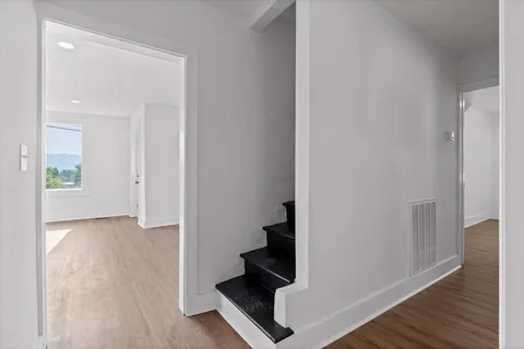 a view of an entryway with wooden floor