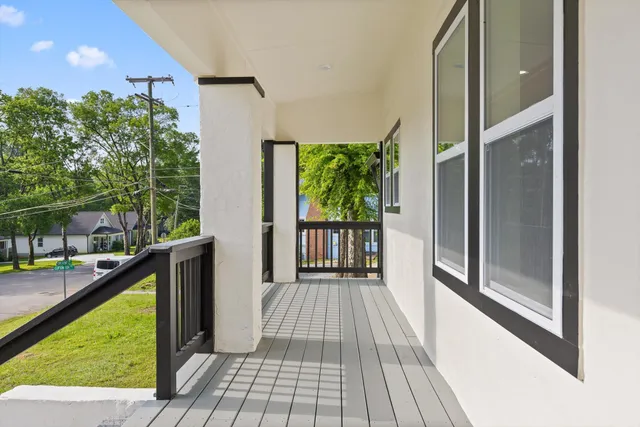 a view of balcony with wooden floor