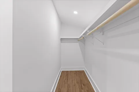 a view of hallway with wooden floor