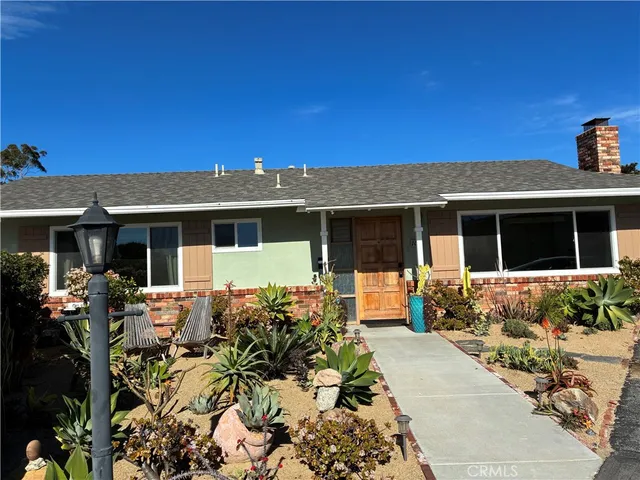 a front view of a house with outdoor seating