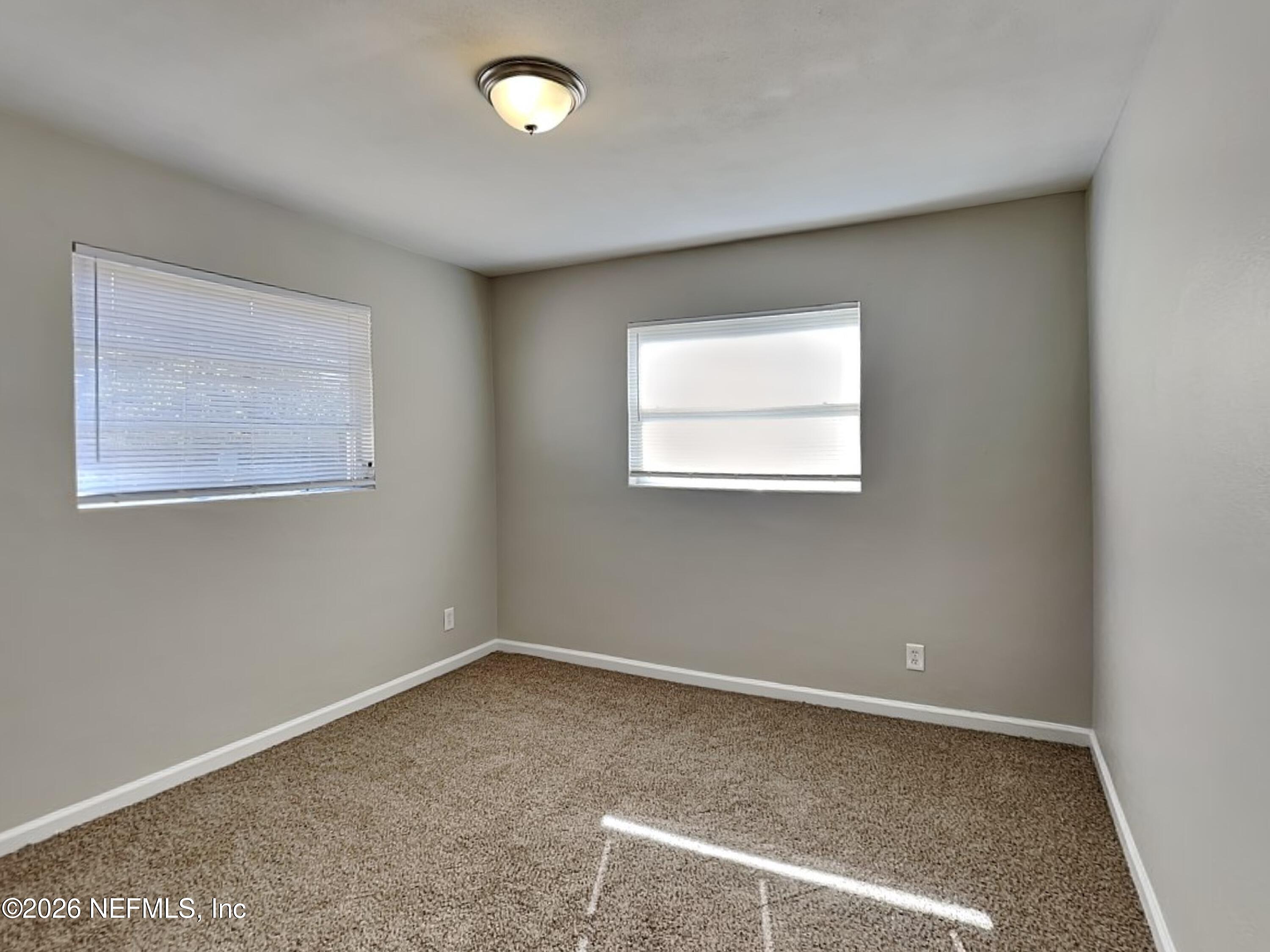 3403 Rogero Road Jacksonville, FL 32277 - Photo 15 of 19 an empty room with a workbench