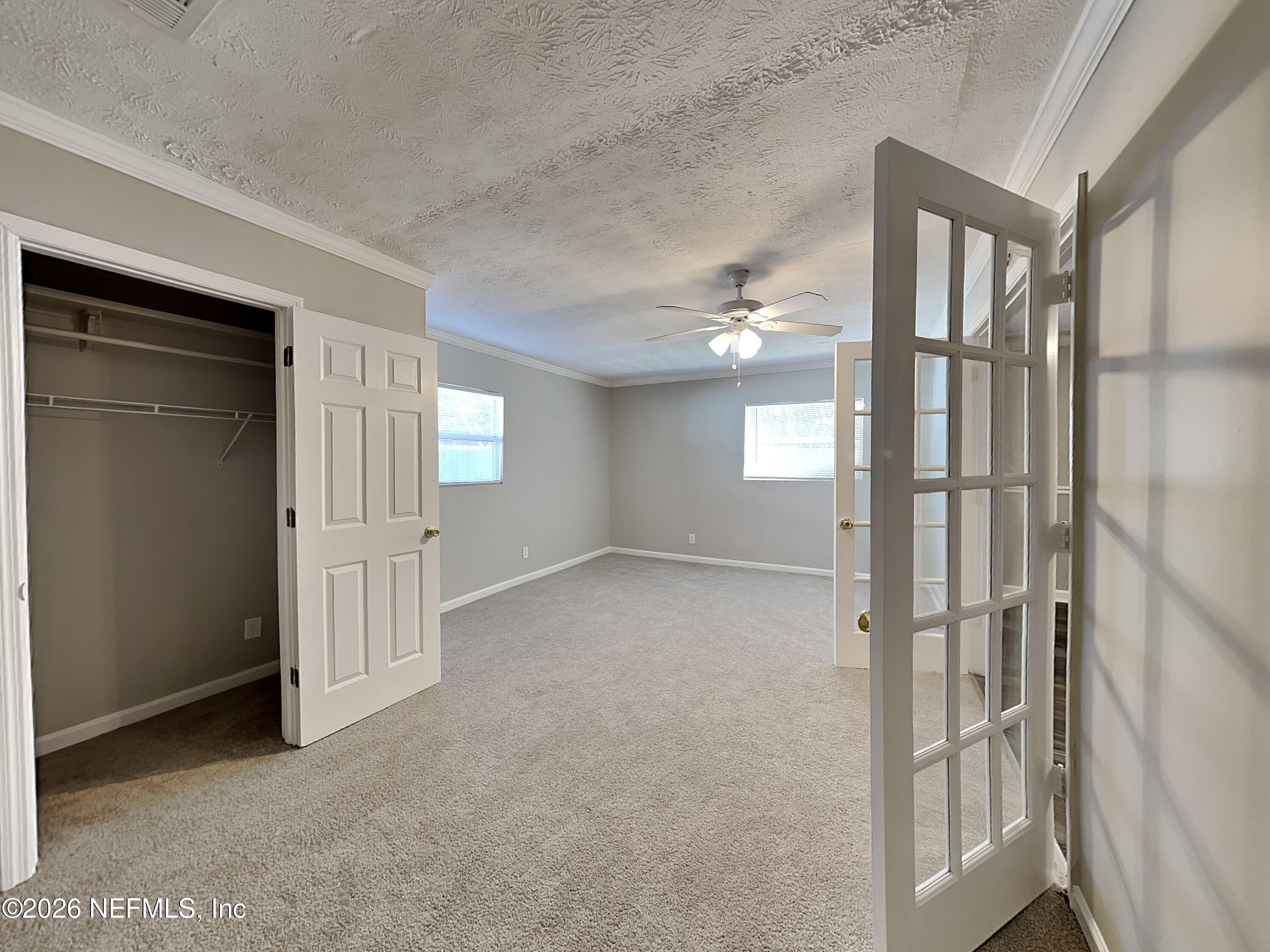 3403 Rogero Road Jacksonville, FL 32277 - Photo 18 of 19 an empty room with windows and entryway